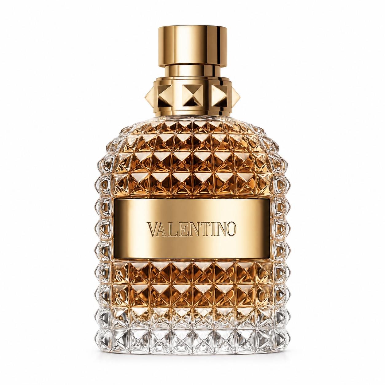 Valentino Uomo Born in Roma Green Stravaganza Eau de Toilette bottle isolated on a white background, featuring a faceted amber-to-clear glass bottle with the signature Rockstud design, gold-tone cap and collar, and metallic Valentino plaque, showcasing its bold luxury aesthetic.