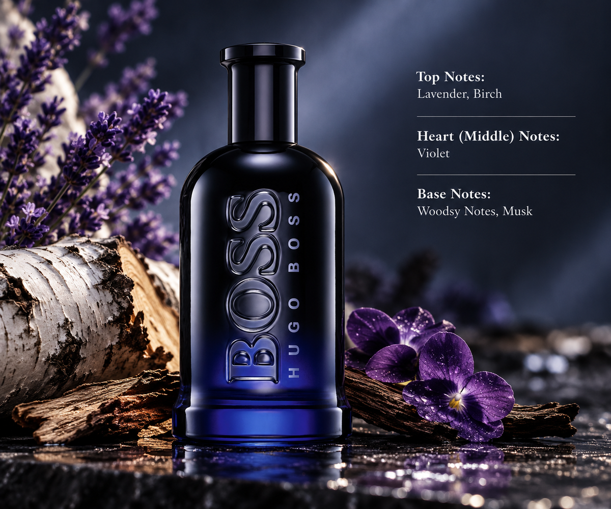 Hugo Boss Bottled Night men's fragrance in a deep blue and black glass bottle with embossed BOSS lettering, surrounded by lavender, birch bark, purple violets and natural wood. Presented on a reflective dark stone surface with moody lighting, highlighting its aromatic, floral and woody scent profile.