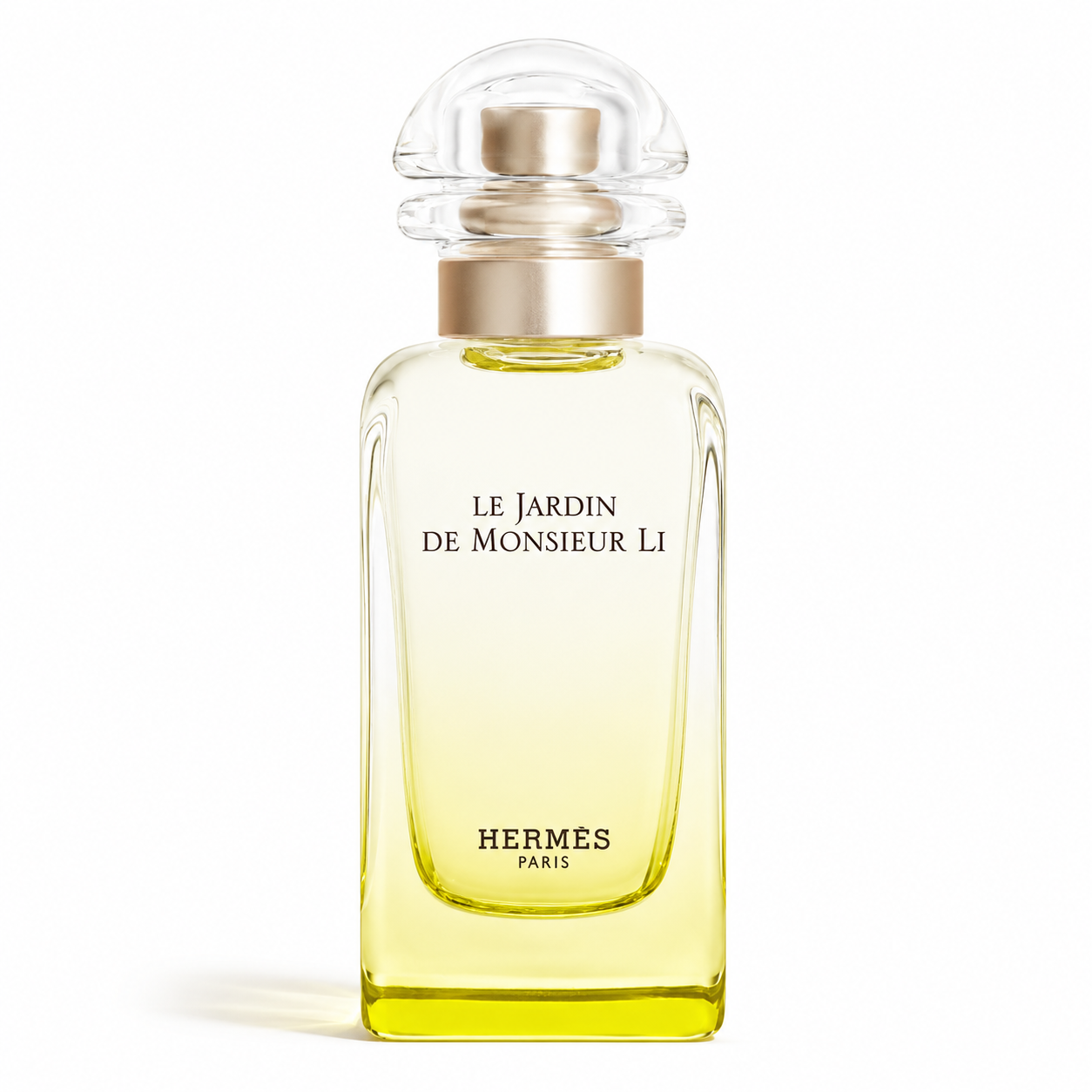Hermès Le Jardin de Monsieur Li 50ml Eau de Toilette for Women and Men in a minimalist clear glass bottle with pale yellow fragrance and a transparent dome cap, isolated on a pure white background.