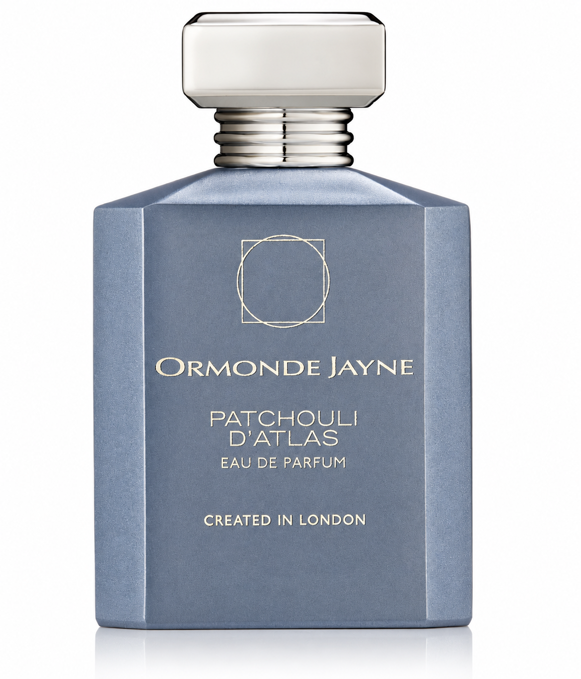 Ormonde Jayne Patchouli D'Atlas Eau de Parfum in an elegant matte blue-grey bottle with a refined geometric design, frosted cap, polished silver collar, and sophisticated gold lettering, presented on a clean white background. Luxury niche perfume showcased in a high-resolution studio product image.