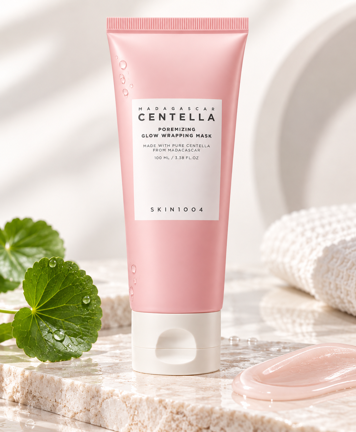 SKIN1004 Madagascar Centella Poremizing Glow Wrapping Mask 100ml displayed with fresh Centella leaves, water droplets and a glossy pink mask texture, highlighting its refreshing pore-care and glow-enhancing skincare concept.
